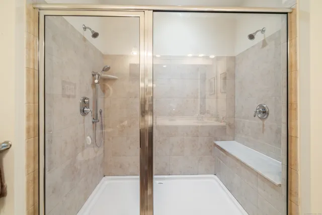 a bathroom with a shower and a tub