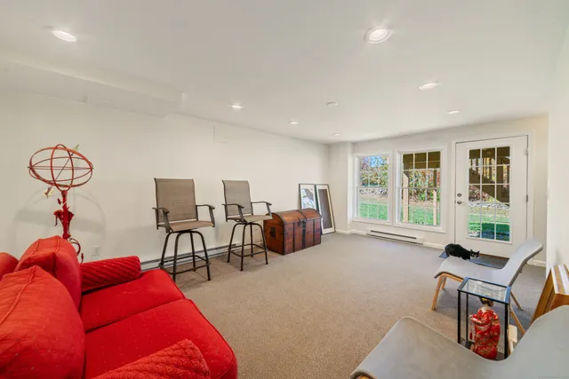 a bedroom with furniture and a large window