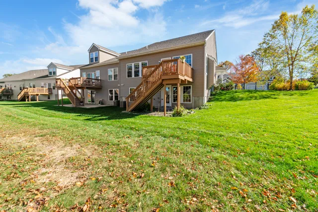 a view of a house with a big yard and large trees