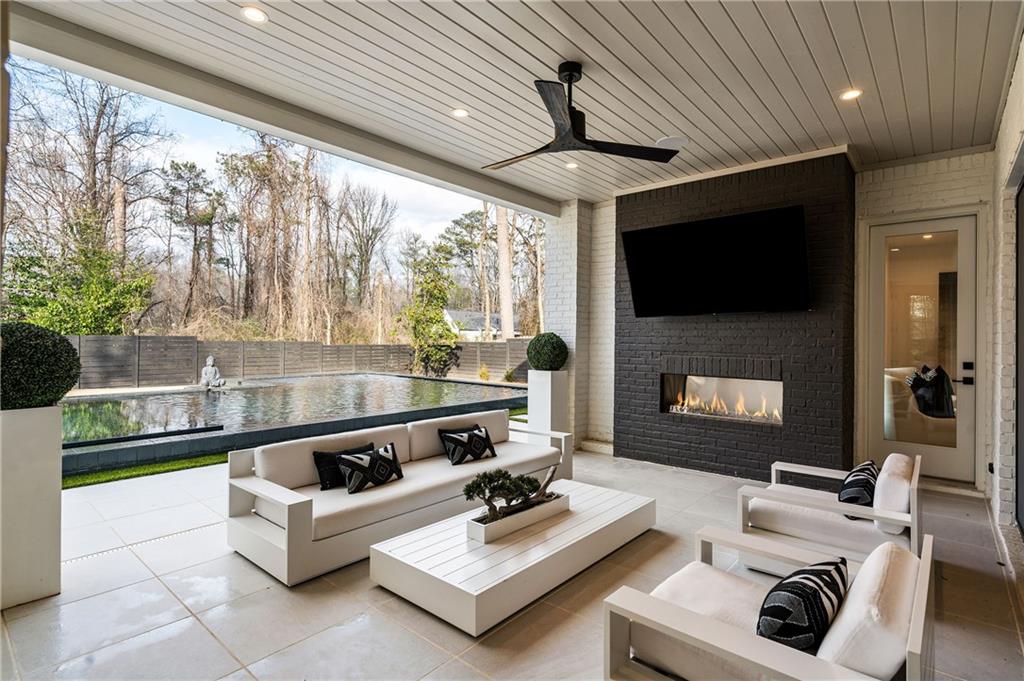 185 Pebble Trail Alpharetta, GA 30009 - Photo 15 of 55 a living room with furniture a flat screen tv and a fireplace