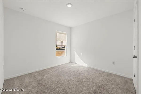 a view of an empty room and a window