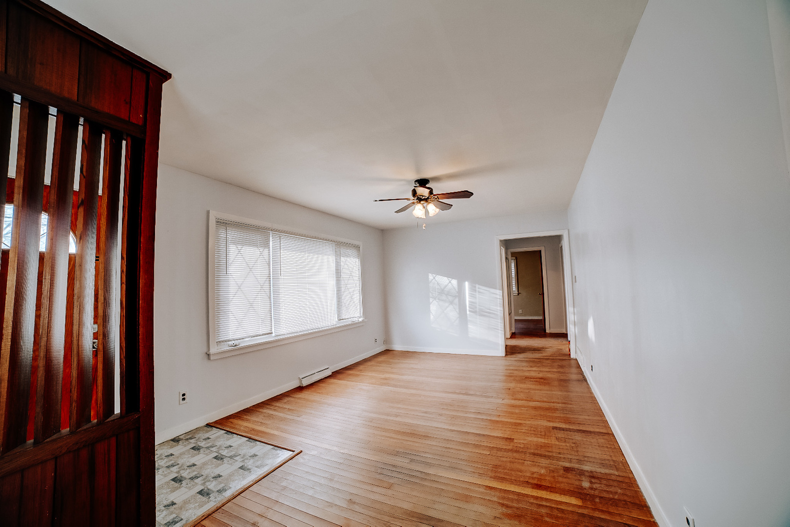 602 East Cherry Street Watseka, IL 60970 - Photo 13 of 29 a view of an empty room with wooden floor and a window