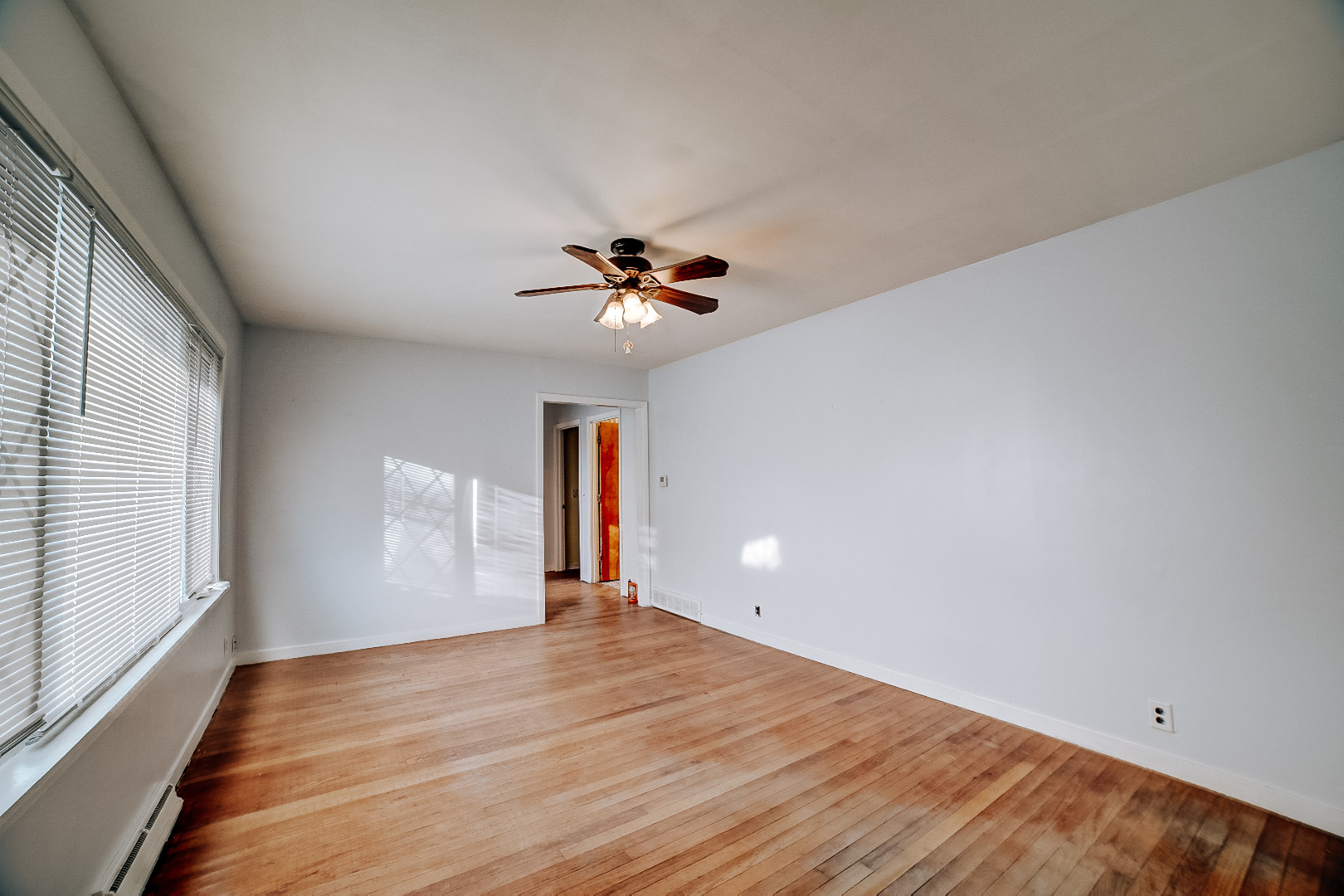 602 East Cherry Street Watseka, IL 60970 - Photo 14 of 29 a view of an empty room with wooden floor and a window
