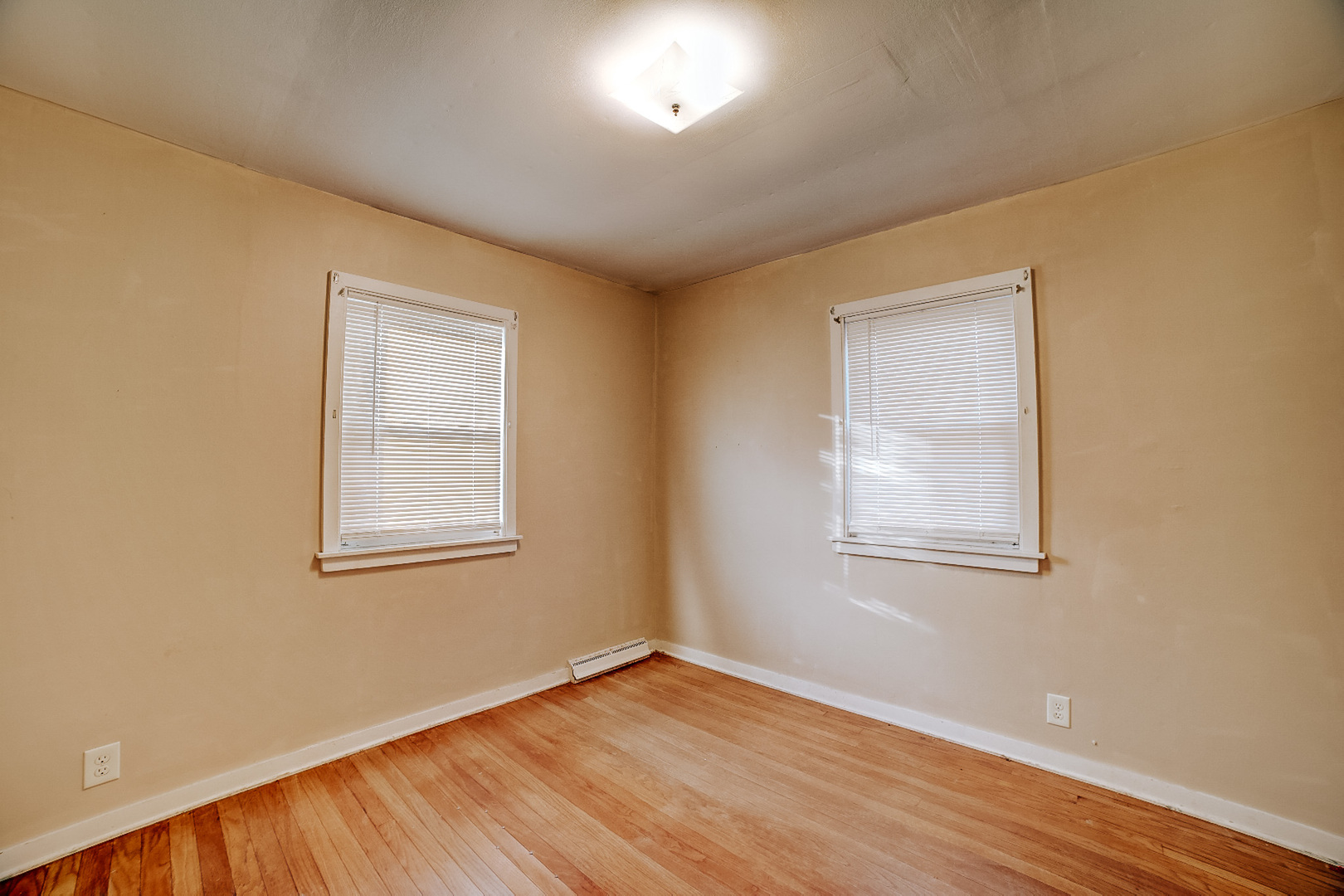 602 East Cherry Street Watseka, IL 60970 - Photo 21 of 29 an empty room with wooden floor and windows
