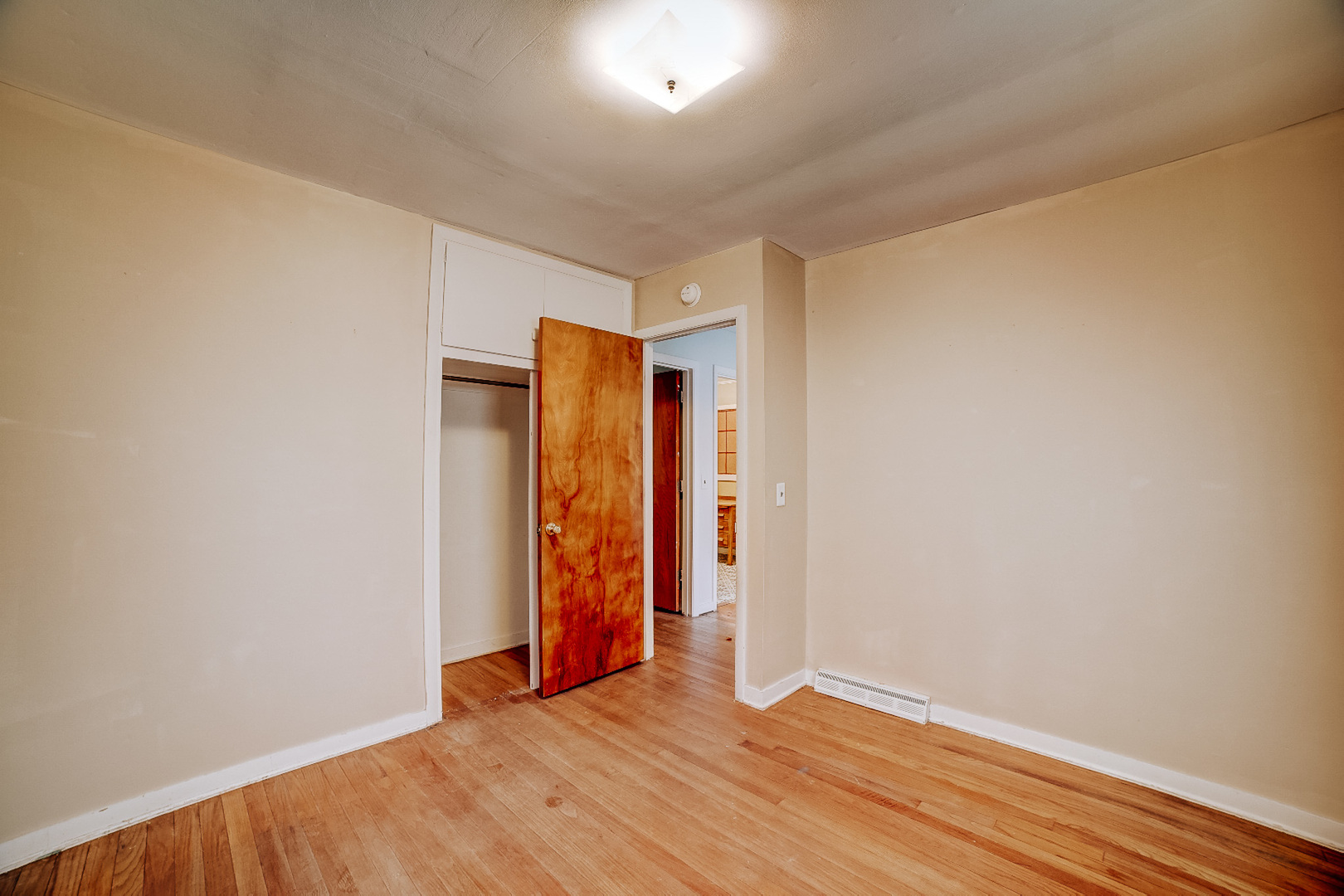 602 East Cherry Street Watseka, IL 60970 - Photo 22 of 29 a view of an empty room with wooden floor and closet