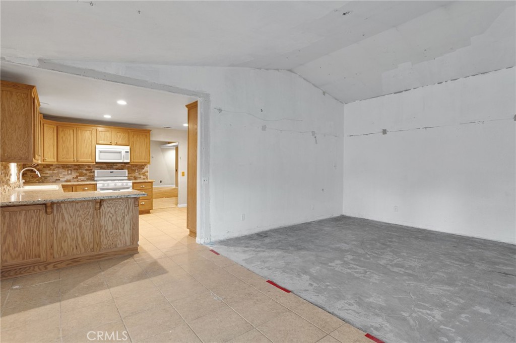 13934 Okesa Road Apple Valley, CA 92307 - Photo 13 of 34 a view of kitchen with center island and windows