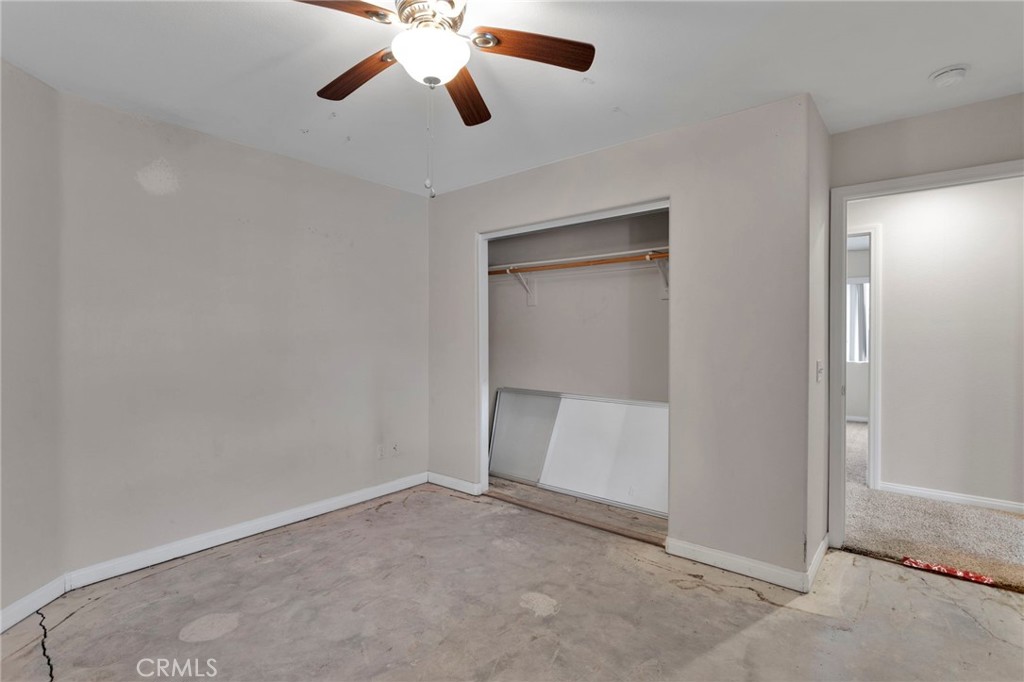 13934 Okesa Road Apple Valley, CA 92307 - Photo 20 of 34 an empty room with a empty space and a ceiling fan