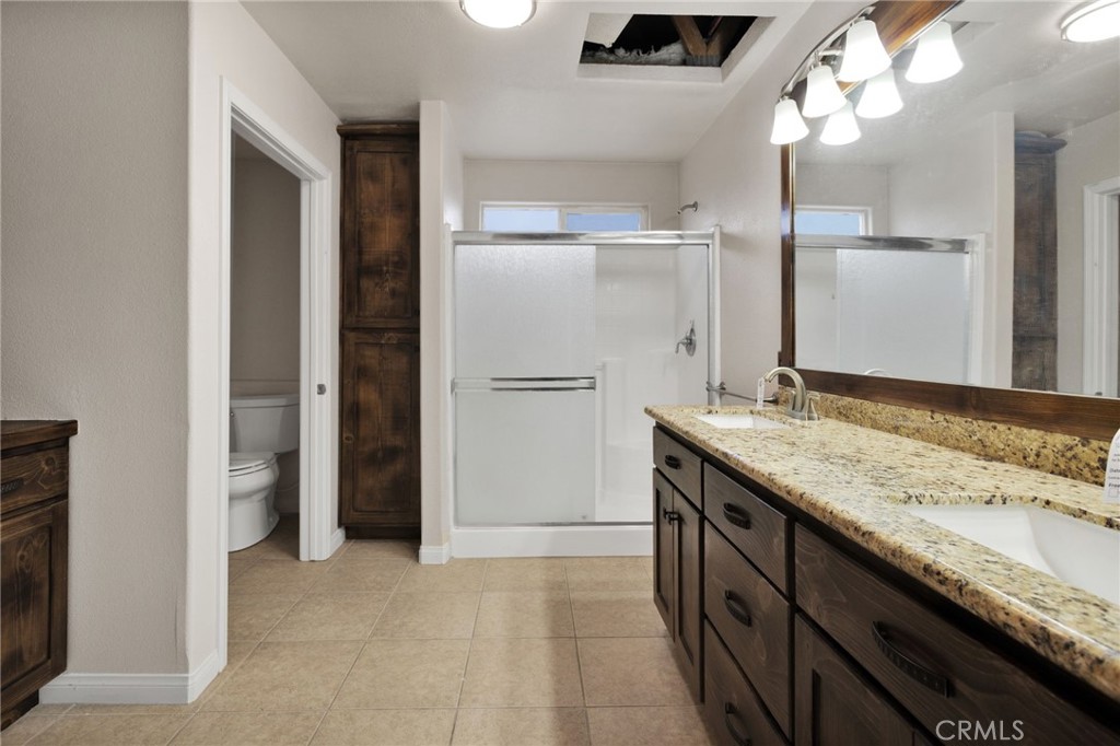 13934 Okesa Road Apple Valley, CA 92307 - Photo 22 of 34 a bathroom with a granite countertop sink and a mirror