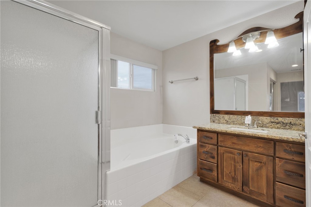13934 Okesa Road Apple Valley, CA 92307 - Photo 26 of 34 a bathroom with a tub sink and mirror