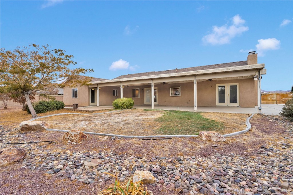 13934 Okesa Road Apple Valley, CA 92307 - Photo 32 of 34 a view of a house with backyard and a tree