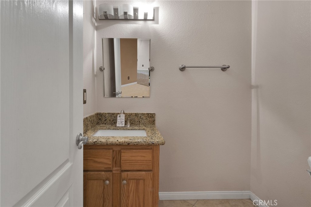 13934 Okesa Road Apple Valley, CA 92307 - Photo 7 of 34 a bathroom with a sink and a mirror