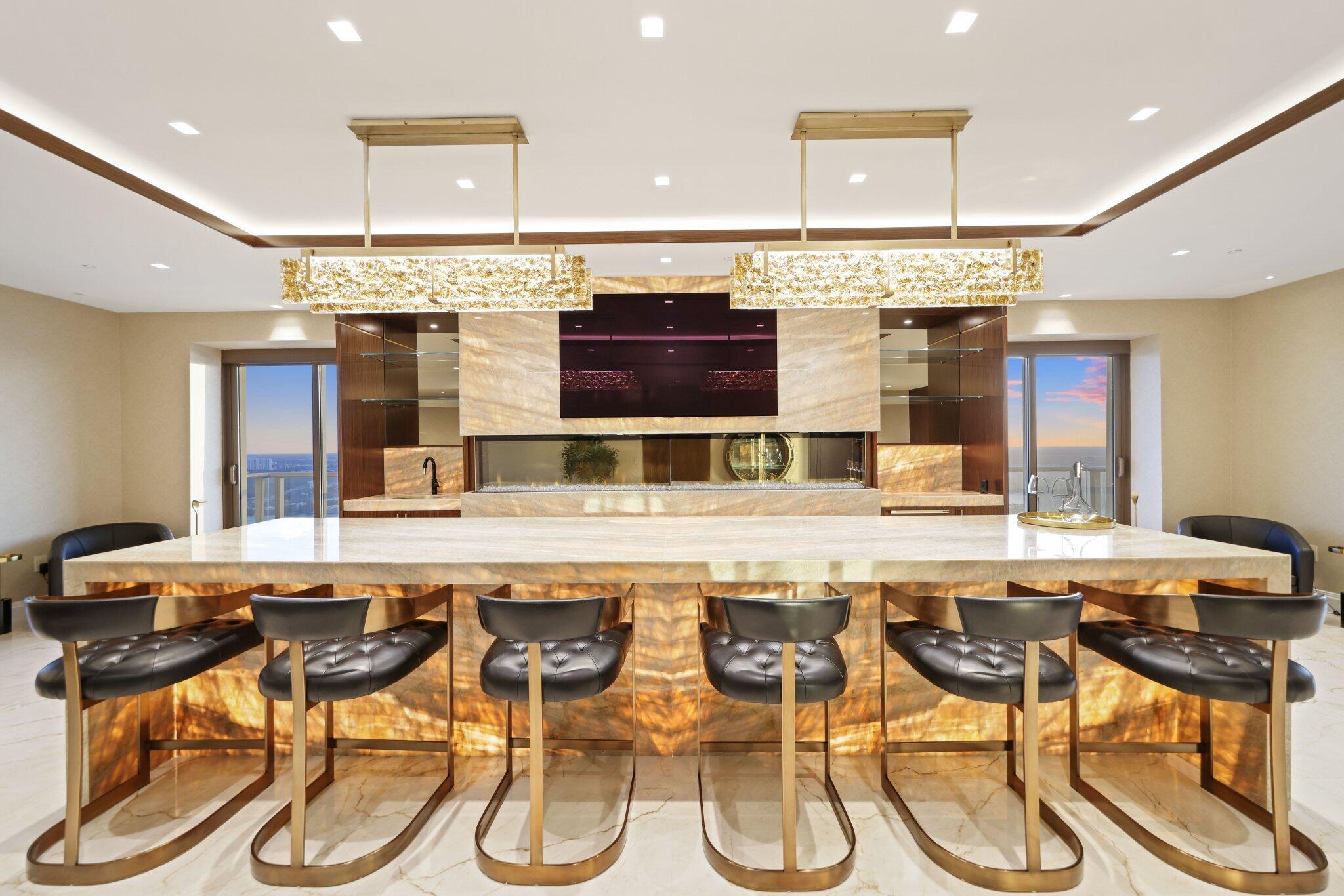 17749 Collins Avenue, Unit TS 3901/3902 Sunny Isles Beach, FL 33160 - Photo 112 of 127 a kitchen with a table and chairs in it