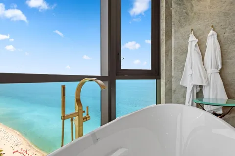 a living room with furniture and a floor to ceiling window