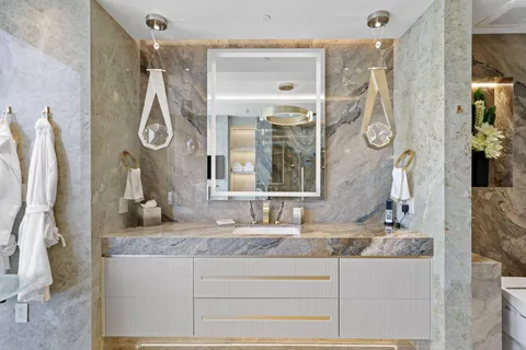 a kitchen with stainless steel appliances granite countertop sink stove and glass door