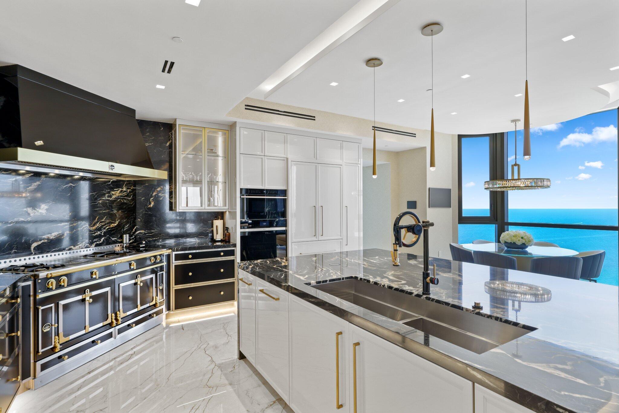 17749 Collins Avenue, Unit TS 3901/3902 Sunny Isles Beach, FL 33160 - Photo 31 of 127 a kitchen with stainless steel appliances kitchen island granite countertop a stove and a sink