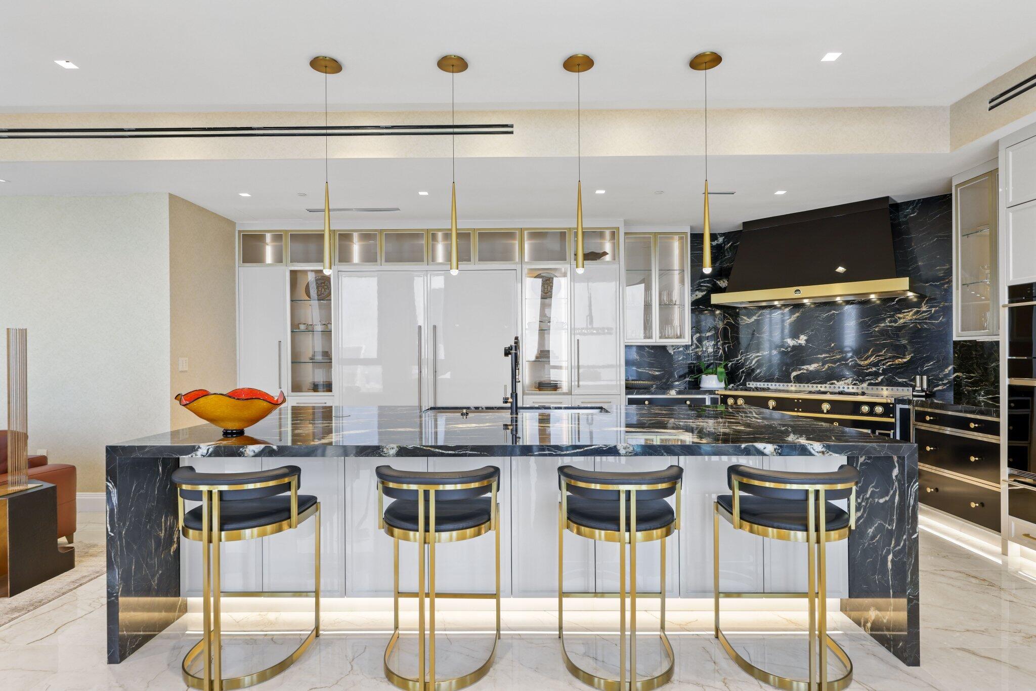 17749 Collins Avenue, Unit TS 3901/3902 Sunny Isles Beach, FL 33160 - Photo 32 of 127 a kitchen with stainless steel appliances kitchen island granite countertop a table and chairs