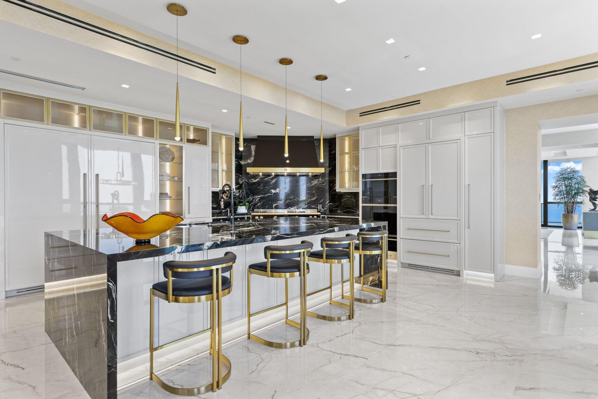 17749 Collins Avenue, Unit TS 3901/3902 Sunny Isles Beach, FL 33160 - Photo 33 of 127 a kitchen with stainless steel appliances kitchen island granite countertop a refrigerator and microwave