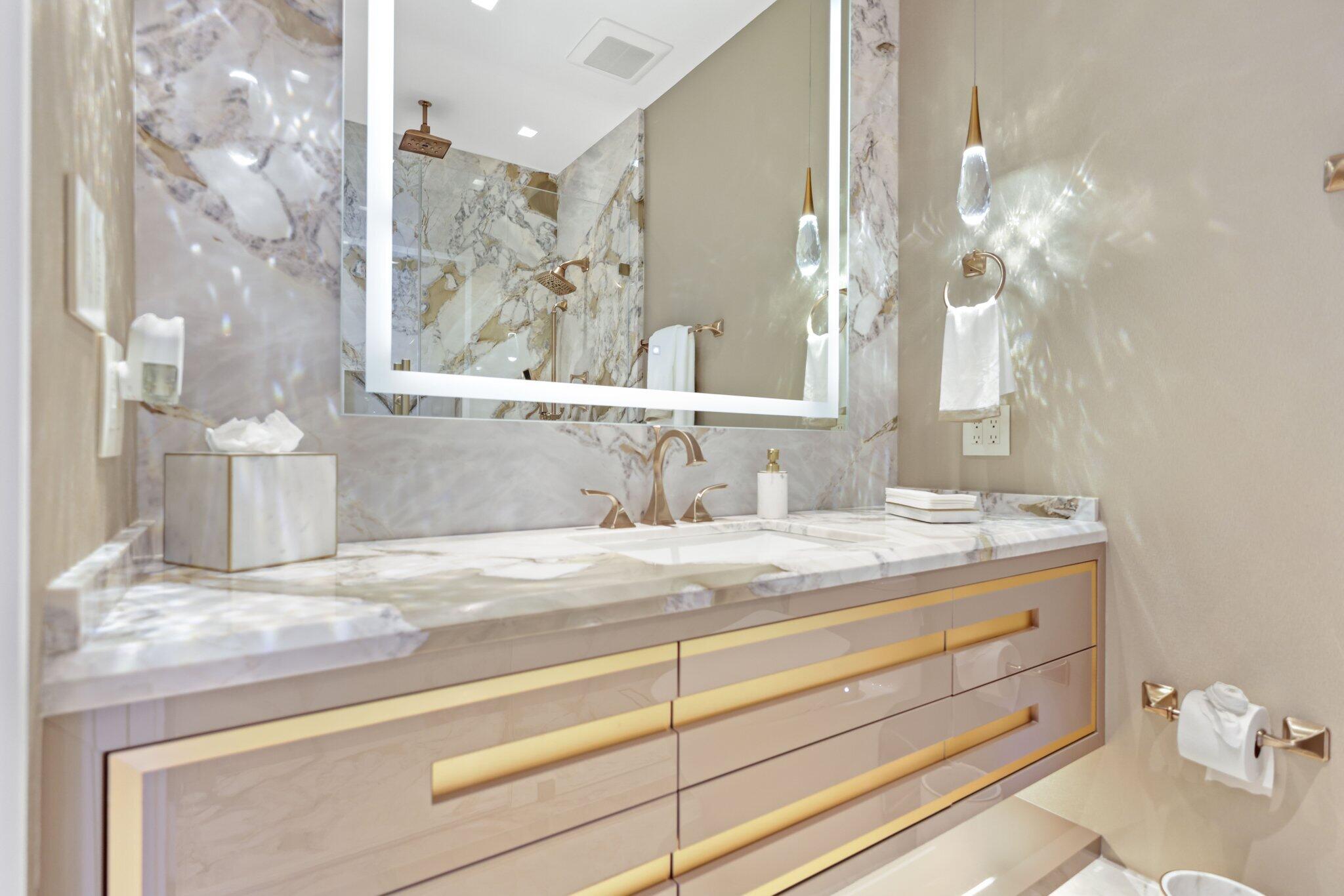 17749 Collins Avenue, Unit TS 3901/3902 Sunny Isles Beach, FL 33160 - Photo 44 of 127 a bathroom with a sink vanity granite and a mirror