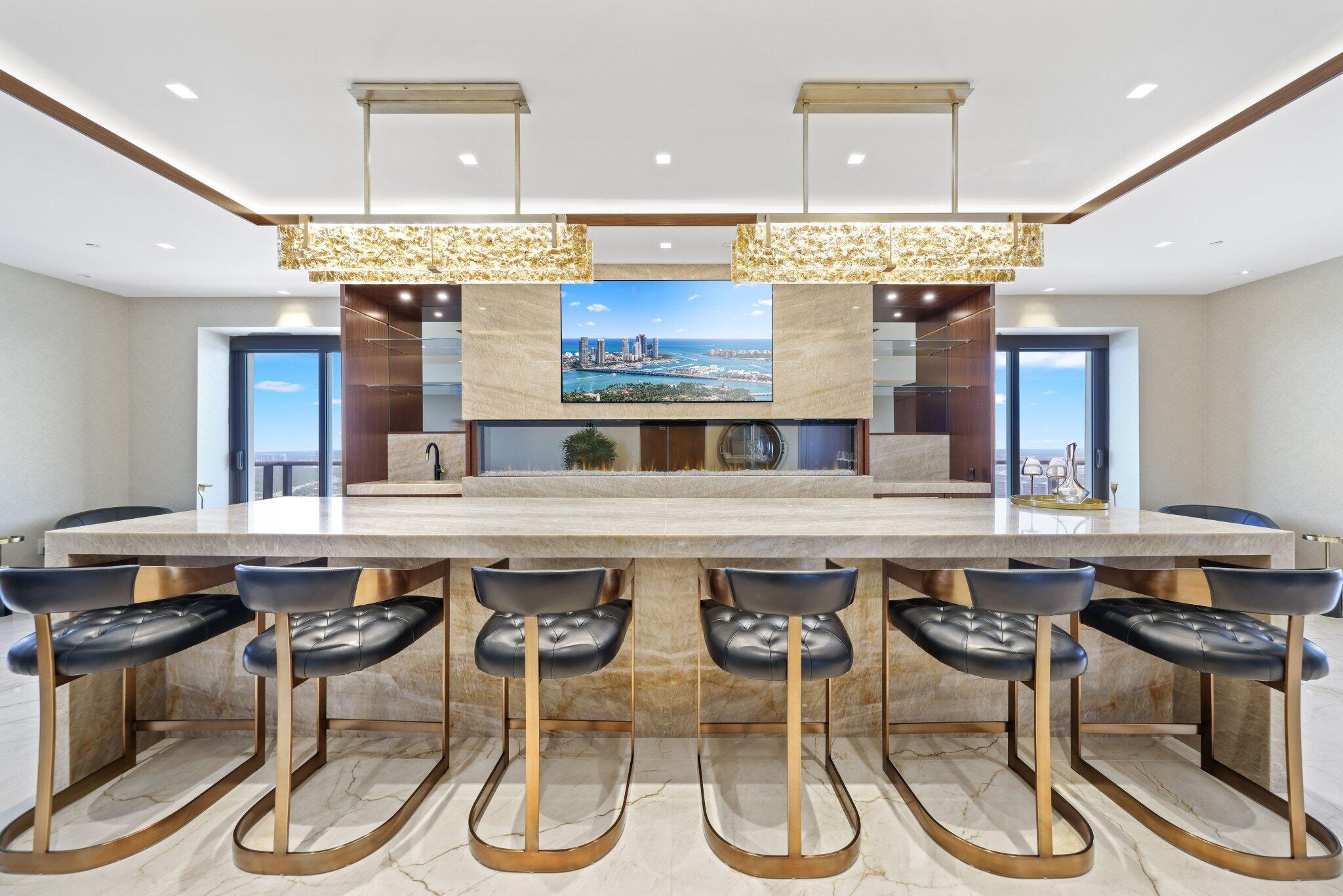 17749 Collins Avenue, Unit TS 3901/3902 Sunny Isles Beach, FL 33160 - Photo 48 of 127 a kitchen with a table and chairs in it