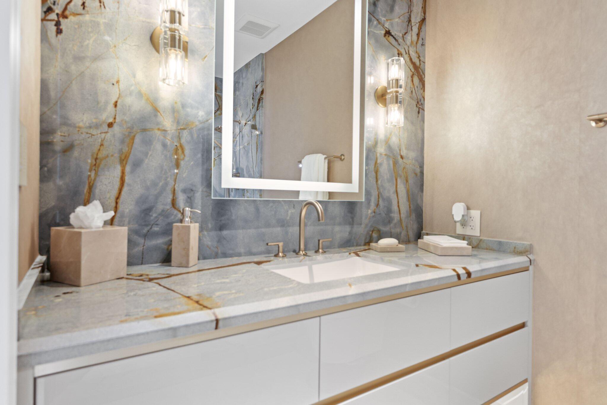 17749 Collins Avenue, Unit TS 3901/3902 Sunny Isles Beach, FL 33160 - Photo 56 of 127 a bathroom with a sink and a mirror