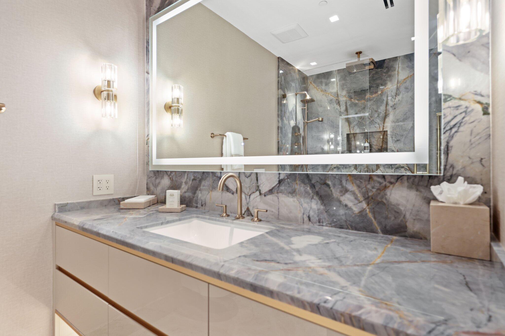 17749 Collins Avenue, Unit TS 3901/3902 Sunny Isles Beach, FL 33160 - Photo 60 of 127 a bathroom with a tub sink and mirror