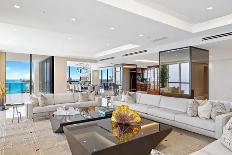 a dining room with furniture a chandelier and wooden floor