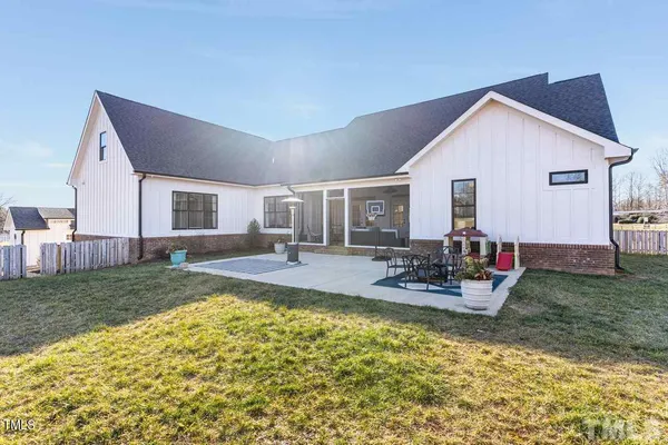 a view of a house with backyard and sitting area