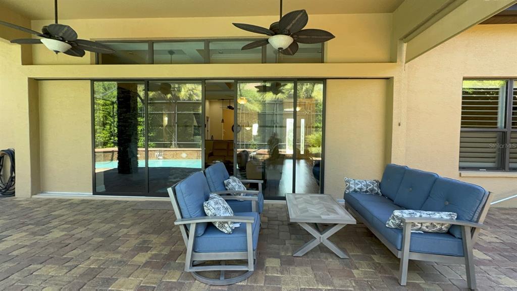 1024 West Beagle Run Loop Hernando, FL 34442 - Photo 34 of 44 a living room with furniture and floor to ceiling windows