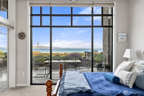 a living room with furniture and a floor to ceiling window
