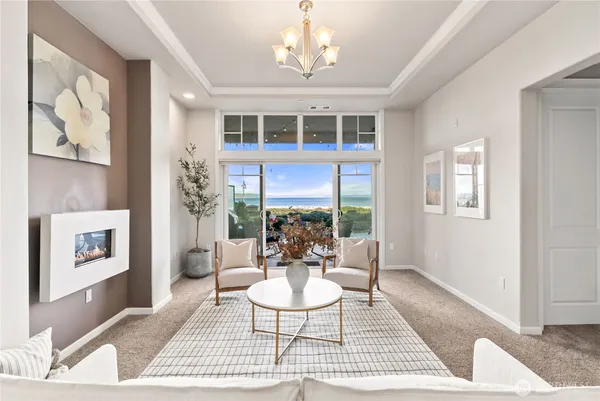 a living room with furniture a table and a large window