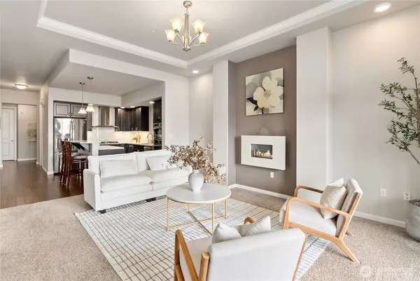 a living room with furniture and a chandelier