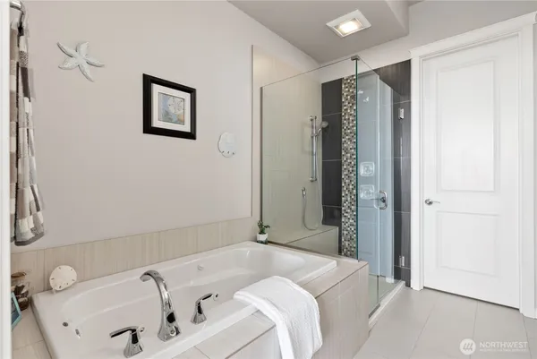 a bathroom with a tub sink and shower