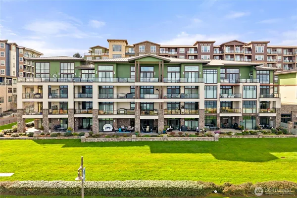a view of an apartment with a swimming pool and a big yard