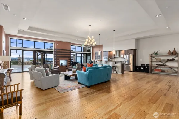 a living room with furniture and a chandelier