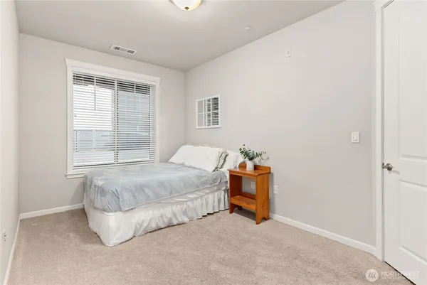 a bedroom with bed and a window