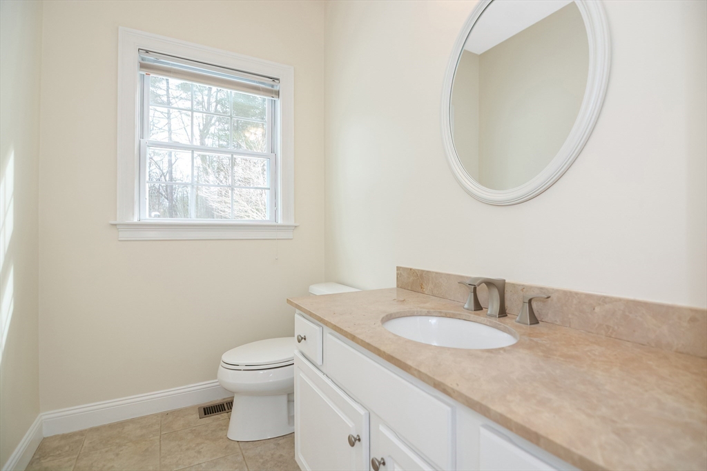 268 Hall Street Dunstable, MA 01827 - Photo 12 of 36 a bathroom with a granite countertop sink mirror and toilet