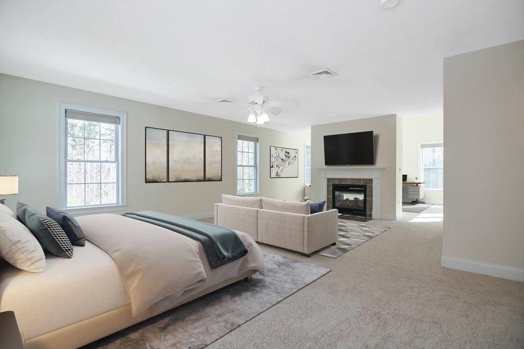 268 Hall Street Dunstable, MA 01827 - Photo 14 of 36 a spacious bedroom with a bed and a fireplace