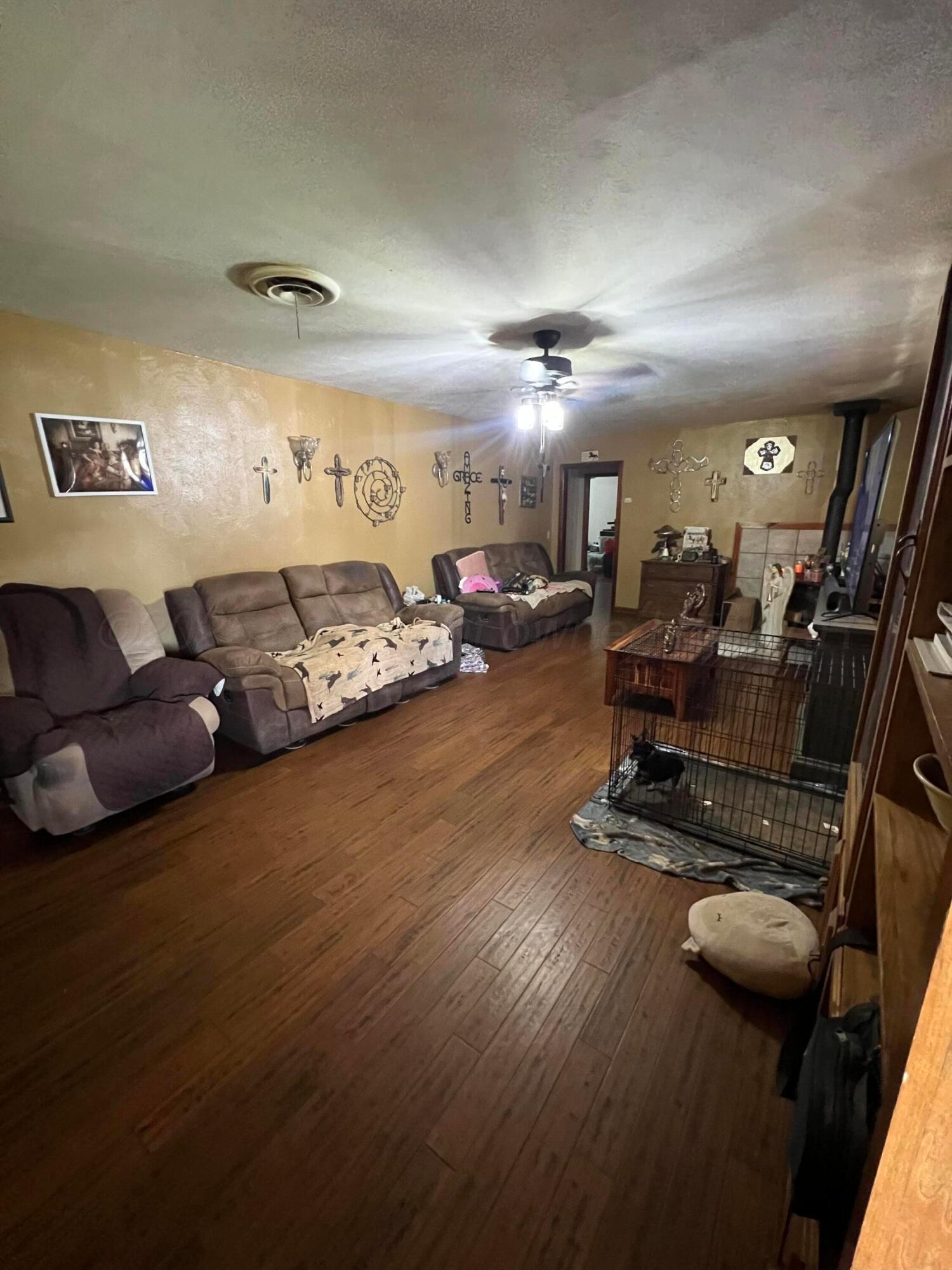 310 East 12th Street Friona, TX 79035 - Photo 5 of 10 a living room with furniture and wooden floor