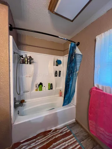 a bathroom with a bathtub and shower