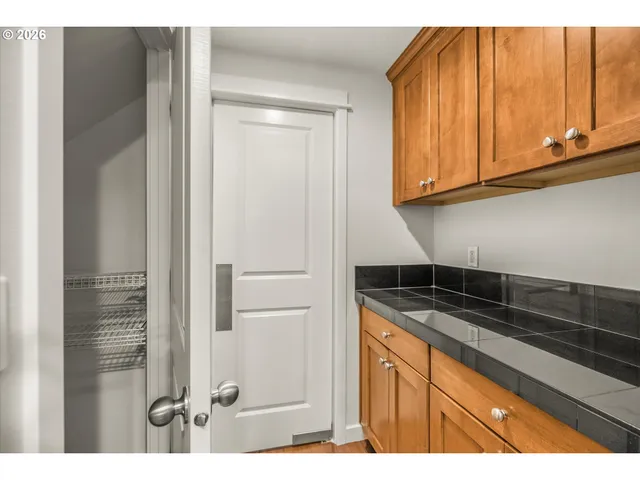 a kitchen with granite countertop stainless steel appliances a sink and cabinets