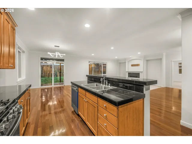 a kitchen with stainless steel appliances granite countertop a sink stove and cabinets