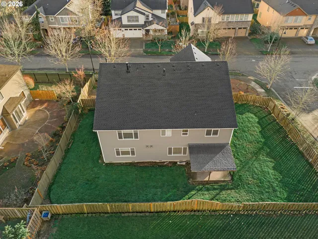 an aerial view of a house with a yard