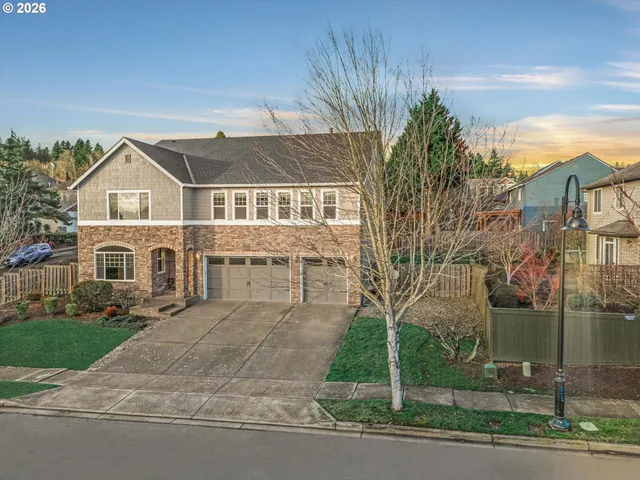 a front view of a house with a garden and plants