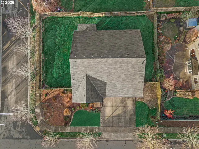 an aerial view of a house with garden space and street view