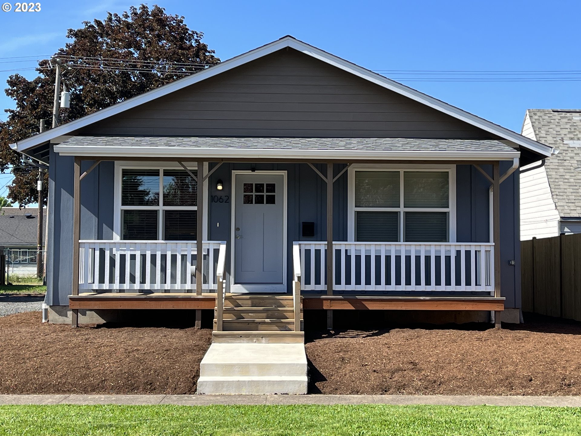 1062 B Street Springfield, OR 97477 - Photo 1 of 33 a view of a house with a small yard and wooden fence