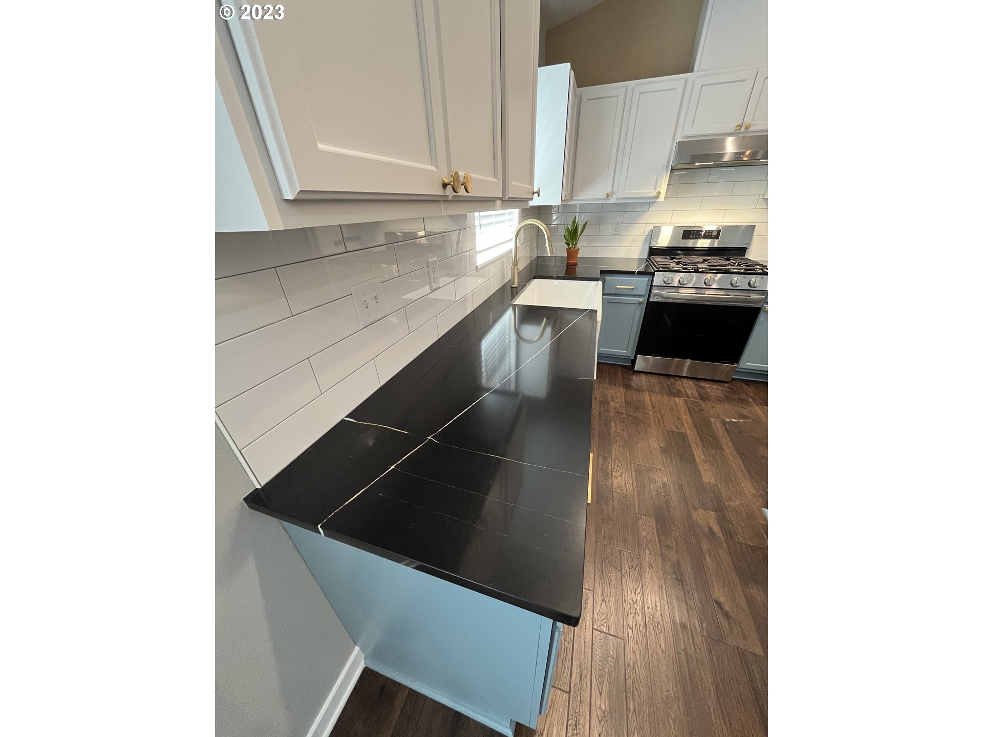1062 B Street Springfield, OR 97477 - Photo 12 of 33 a kitchen with a sink and a stove with wooden floor