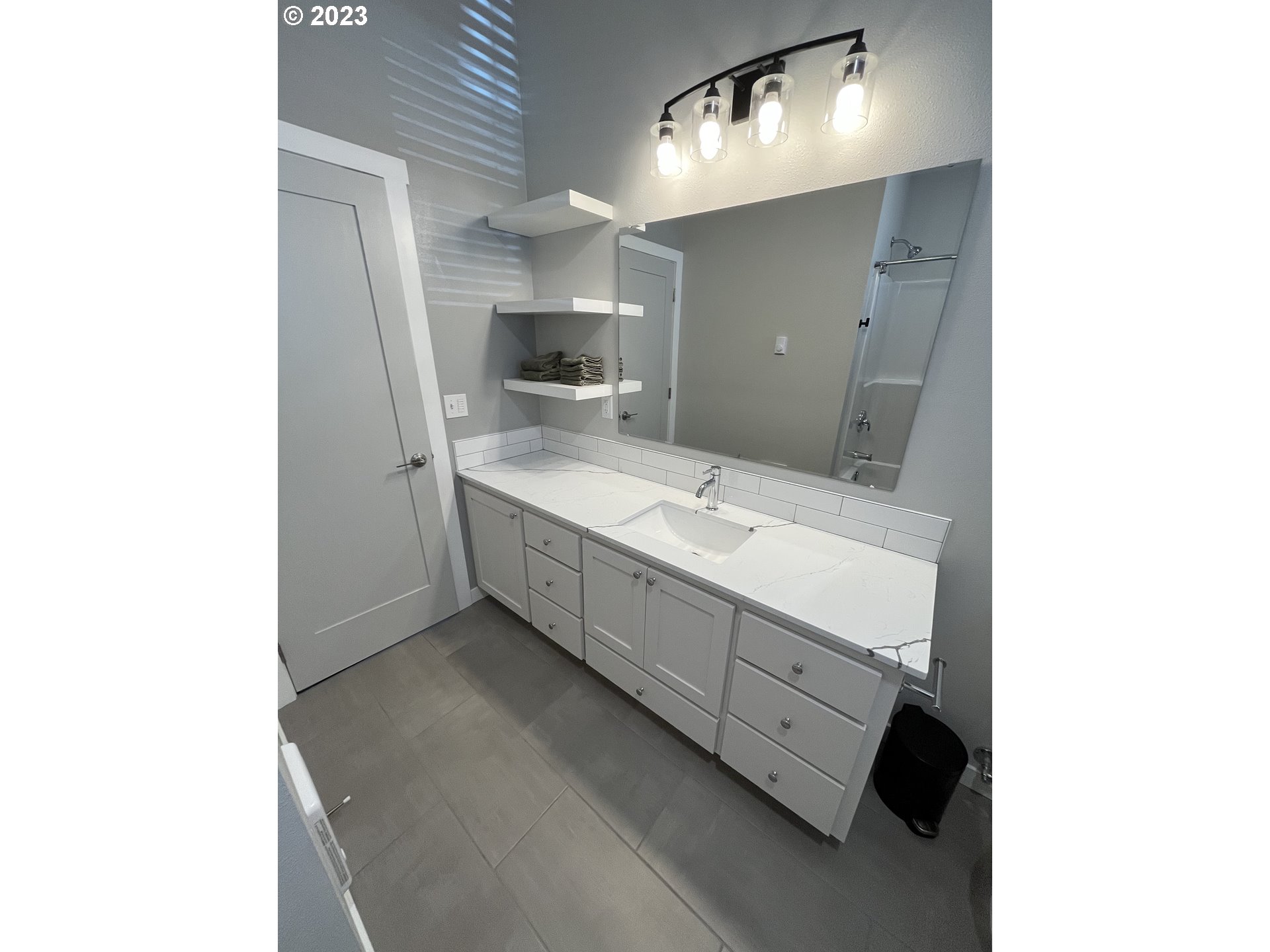1062 B Street Springfield, OR 97477 - Photo 17 of 33 a bathroom with a double vanity sink and a mirror