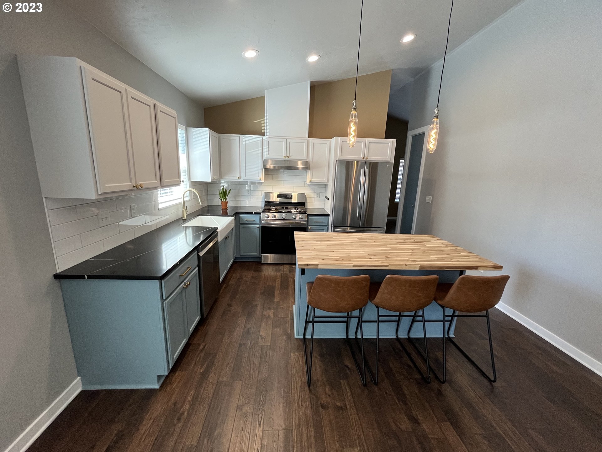 1062 B Street Springfield, OR 97477 - Photo 6 of 33 a kitchen with stainless steel appliances granite countertop a table chairs sink refrigerator and cabinets
