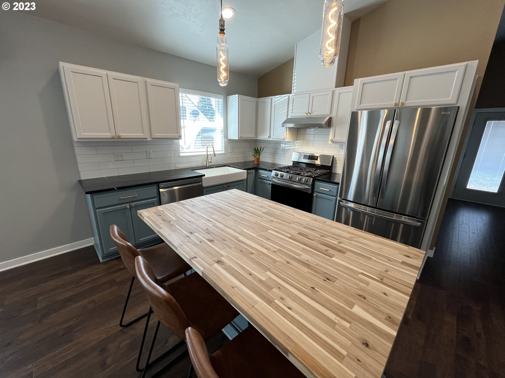 1062 B Street Springfield, OR 97477 - Photo 7 of 33 a kitchen with a table chairs refrigerator and microwave