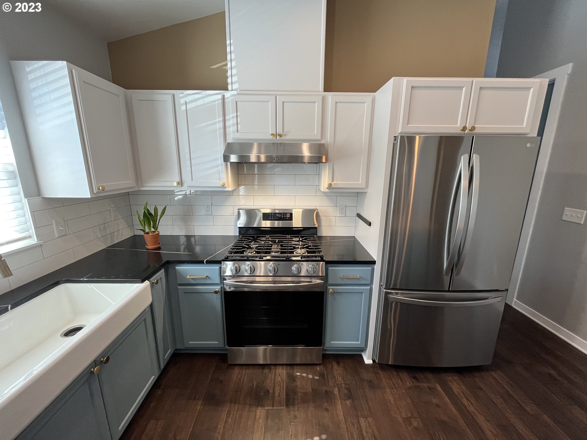 1062 B Street Springfield, OR 97477 - Photo 8 of 33 a kitchen with a refrigerator sink and wooden floor